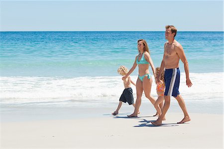 simsearch:6109-06003758,k - Side view of young family walking together along the beach Stock Photo - Premium Royalty-Free, Code: 6109-06003764