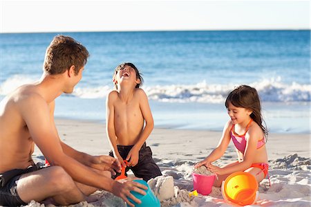 sand sea kids - Father playing with his little children on the beach Foto de stock - Sin royalties Premium, Código: 6109-06003789