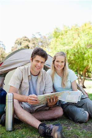 simsearch:6109-06003893,k - A smiling couple hold a map and read off of it while they camp together Stock Photo - Premium Royalty-Free, Code: 6109-06003877
