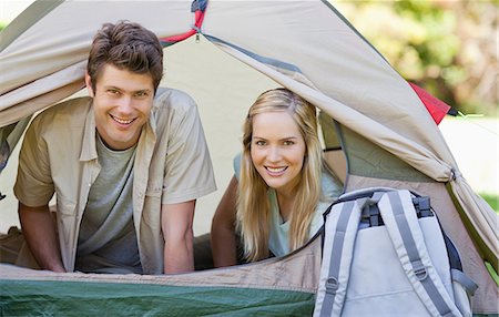 simsearch:6109-06003893,k - A couple lying inside their tent look out smiling Stock Photo - Premium Royalty-Free, Code: 6109-06003885