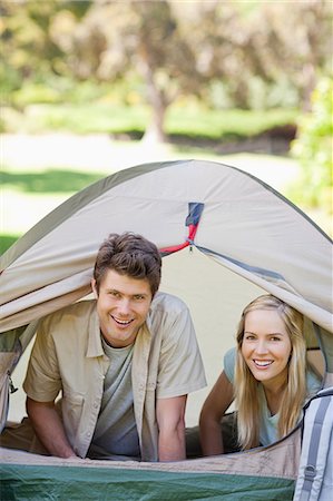 simsearch:6109-06003893,k - A couple having a lot of fun camping together as they smile Stock Photo - Premium Royalty-Free, Code: 6109-06003886
