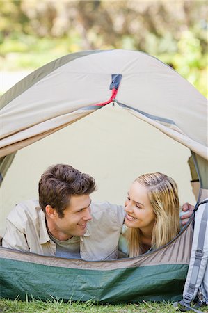 simsearch:6109-06003893,k - A couple in the same tent look at each other and smile while camping Stock Photo - Premium Royalty-Free, Code: 6109-06003891