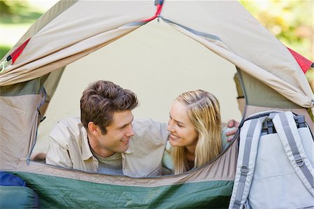 simsearch:6109-06003893,k - A couple smiling as they lie in their tent holding each other Stock Photo - Premium Royalty-Free, Code: 6109-06003892