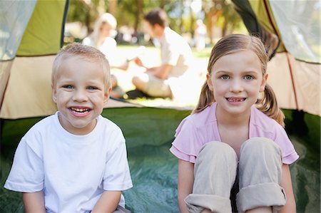 simsearch:6109-06003893,k - Happy smiling kids sit inside of the tent with their parents outside chatting Stock Photo - Premium Royalty-Free, Code: 6109-06003912