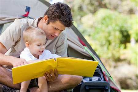 simsearch:6109-06003893,k - A father read a book with his son by the tent Stock Photo - Premium Royalty-Free, Code: 6109-06003928