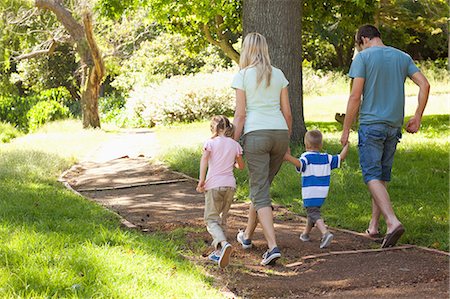 park child walk - A family walking down a path in the park Stock Photo - Premium Royalty-Free, Code: 6109-06004007