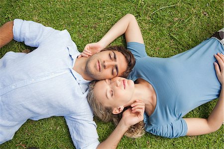 Young couple relaxing on the lawn together Stock Photo - Premium Royalty-Free, Code: 6109-06004353