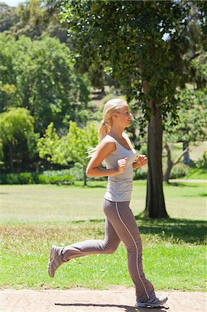 sporty - Side view of a running young sportswoman Stock Photo - Premium Royalty-Free, Code: 6109-06004313