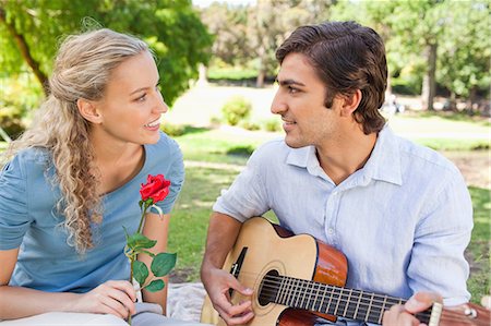 Young woman listening to her boyfriend playing the guitar Stock Photo - Premium Royalty-Free, Code: 6109-06004403