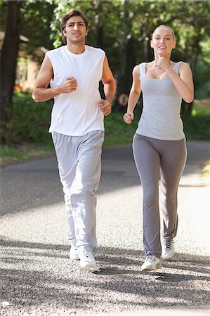 sporty - Young sportspeople jogging on an avenue Stock Photo - Premium Royalty-Free, Code: 6109-06004562