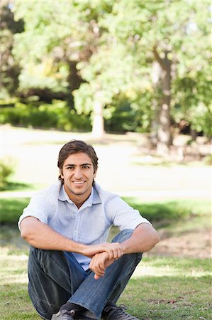 simsearch:6109-06003893,k - Smiling young man sitting on the grass Stock Photo - Premium Royalty-Free, Code: 6109-06004503
