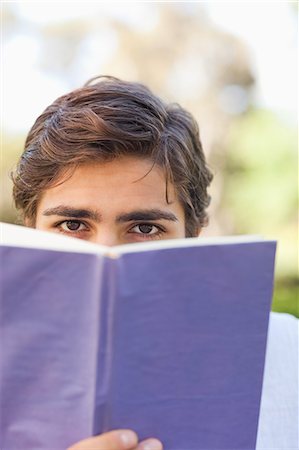 simsearch:6109-06003893,k - Young man looking over his book Stock Photo - Premium Royalty-Free, Code: 6109-06004518