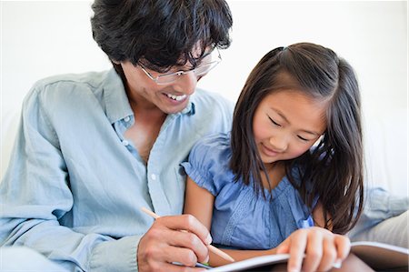 pretty pictures to draw - A smiling dad helps his daughter to do her homework on the couch Stock Photo - Premium Royalty-Free, Code: 6109-06004909