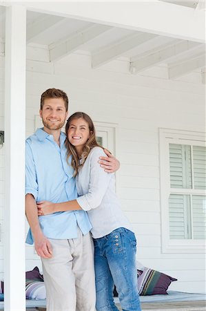 porch white - A smiling man and woman looking up from the porch outside Stock Photo - Premium Royalty-Free, Code: 6109-06005193