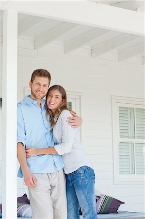 porch white - A man and woman on the porch smiling as the man rests against the wooden beam Stock Photo - Premium Royalty-Free, Code: 6109-06005191