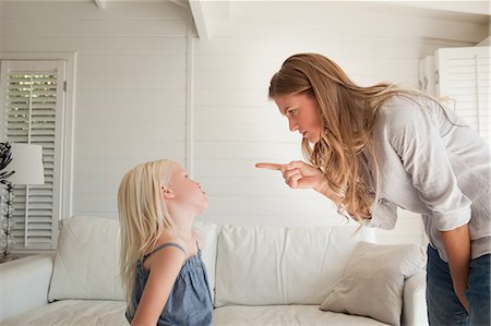 A mother points her finger at her daughter to punish her for doing something bad Stock Photo - Premium Royalty-Free, Code: 6109-06005135