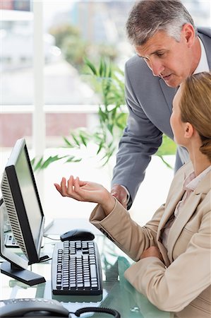 Workers in a suit talking in a bright office Stock Photo - Premium Royalty-Free, Code: 6109-06005277