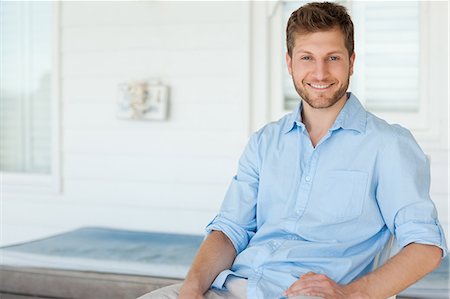 A man sitting in the porch smiling looking straight ahead Stock Photo - Premium Royalty-Free, Code: 6109-06005219