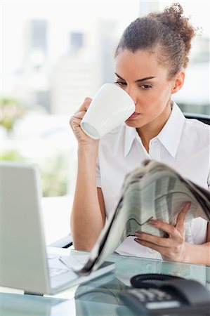 relaxation in the office - Businesswoman drinking a coffee and reading the news in bright office Stock Photo - Premium Royalty-Free, Code: 6109-06005373