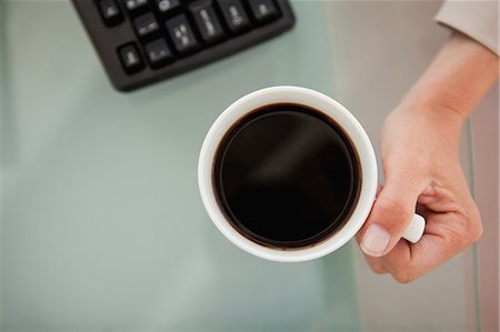 person holding cup of coffee - Close-up of a coffee with a high angle-shot taken by a woman Stock Photo - Premium Royalty-Free, Code: 6109-06005468