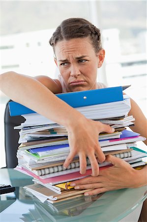 filing (organization) - Upset businesswoman getting too much work in a bright office Stock Photo - Premium Royalty-Free, Code: 6109-06005511