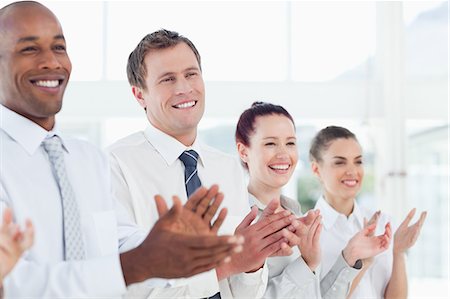 pictures of people standing together - Smiling young salesteam giving applause Stock Photo - Premium Royalty-Free, Code: 6109-06005763