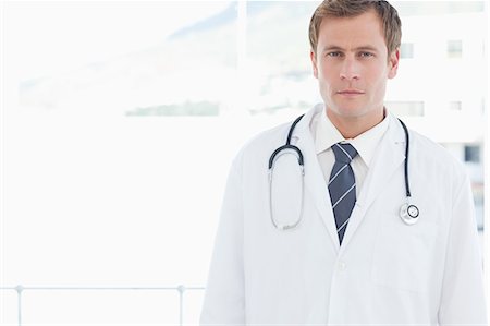 simsearch:6109-06005907,k - Male doctor standing in front of a window Stock Photo - Premium Royalty-Free, Code: 6109-06005869