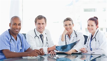 simsearch:6109-06005907,k - Smiling medical staff sitting together at a table Stock Photo - Premium Royalty-Free, Code: 6109-06005872