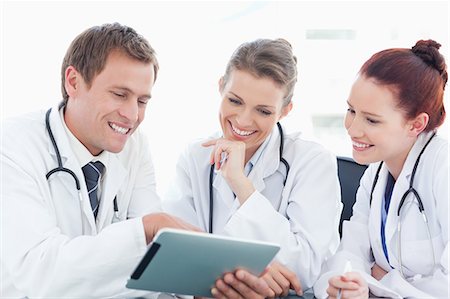 simsearch:6109-06005907,k - Smiling doctors using tablet Stock Photo - Premium Royalty-Free, Code: 6109-06005880