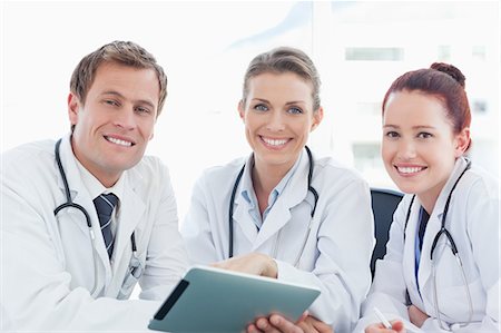 simsearch:6109-06005907,k - Smiling doctors with tablet computer Stock Photo - Premium Royalty-Free, Code: 6109-06005881