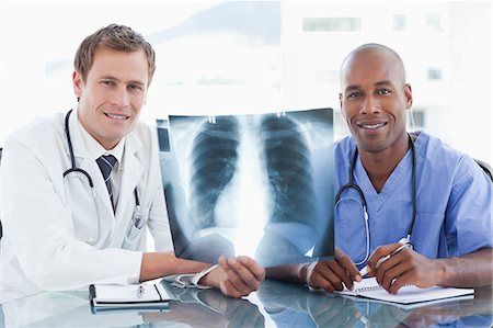 simsearch:6109-06005907,k - Smiling young doctors holding an x-ray Stock Photo - Premium Royalty-Free, Code: 6109-06005888