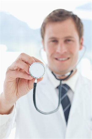 simsearch:6109-06005907,k - Stethoscope being used by smiling doctor Stock Photo - Premium Royalty-Free, Code: 6109-06005892