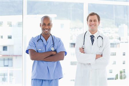 simsearch:6109-06005907,k - Smiling doctors with their arms folded Stock Photo - Premium Royalty-Free, Code: 6109-06005898