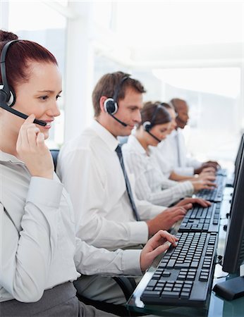 Young call center employees sitting in a line Stock Photo - Premium Royalty-Free, Code: 6109-06005811