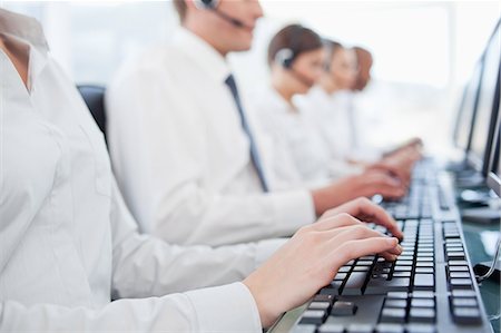 Hands of call center agents working on keyboards Stock Photo - Premium Royalty-Free, Code: 6109-06005819