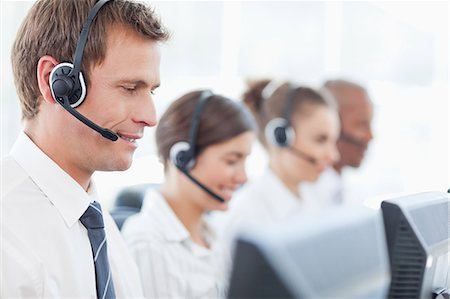 Side view of young call center agents at work Stock Photo - Premium Royalty-Free, Code: 6109-06005823