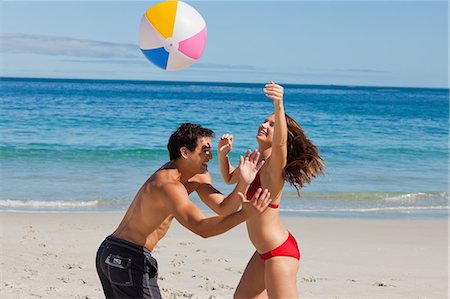simsearch:6109-06004195,k - Young couple in swim suit playing with a beach ball on the beach Stock Photo - Premium Royalty-Free, Code: 6109-06005961