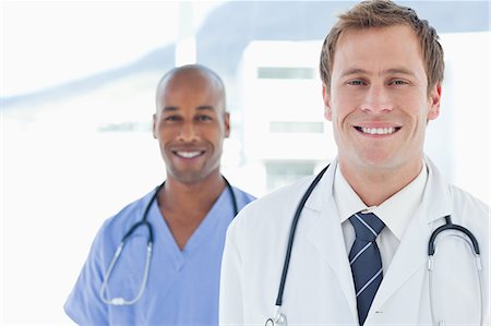 simsearch:6109-06005907,k - Smiling male doctors standing in line Stock Photo - Premium Royalty-Free, Code: 6109-06005900