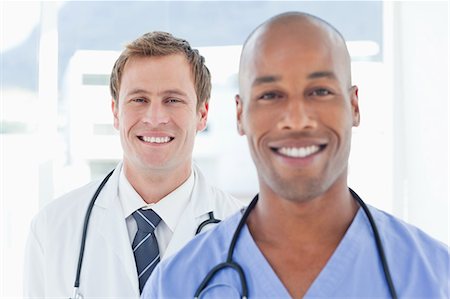 simsearch:6109-06005907,k - Smiling male doctors standing in a row Stock Photo - Premium Royalty-Free, Code: 6109-06005901