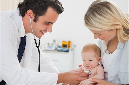 doctors girls hospital - Smiling male doctor measuring little babys heart beat Stock Photo - Premium Royalty-Free, Code: 6109-06006453