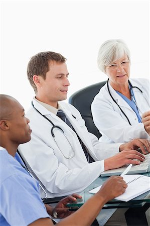 Three doctors using laptop together Stock Photo - Premium Royalty-Free, Code: 6109-06006476