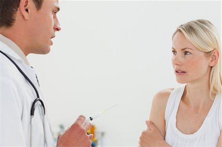 Male doctor talking with his patient about an injection Stock Photo - Premium Royalty-Free, Code: 6109-06006415