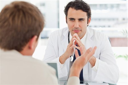 doctor happy patient adult - Man talking to his young doctor Stock Photo - Premium Royalty-Free, Code: 6109-06006553