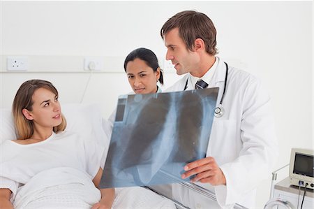 simsearch:6109-06006928,k - Serious doctor talking to a patient about her x-ray while standing upright Stock Photo - Premium Royalty-Free, Code: 6109-06007040