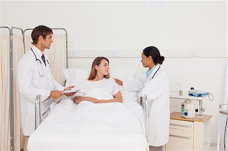 simsearch:6109-06006928,k - Calm patient lying in a hospital bed while being accompanied by two surgeons Stock Photo - Premium Royalty-Free, Code: 6109-06007047