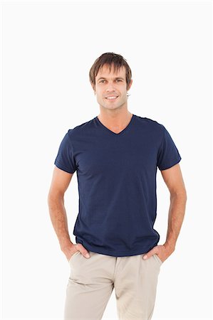 standing - Happy man standing up with his hands in his pockets against a white background Stock Photo - Premium Royalty-Free, Code: 6109-06007099