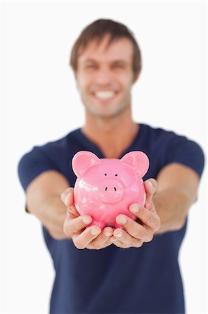 piggy bank - Piggy bank held by a young man against a white background Stock Photo - Premium Royalty-Free, Code: 6109-06007157