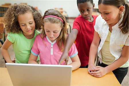 Elementary students working on laptop Stock Photo - Premium Royalty-Free, Code: 6109-06007395
