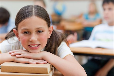 simsearch:6109-06007455,k - Primary student leaning on a pile of books Stock Photo - Premium Royalty-Free, Code: 6109-06007454