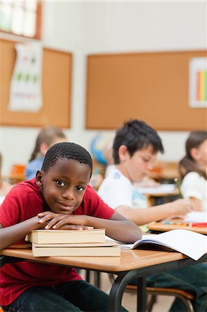 simsearch:6109-06007455,k - Smiling elementary student leaning on a stack of books Stock Photo - Premium Royalty-Free, Code: 6109-06007480